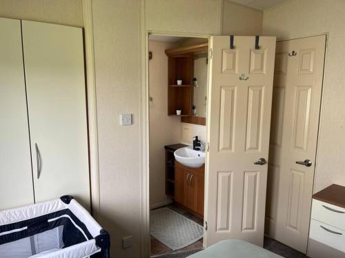 a small bathroom with a sink and a toilet at Beautiful Seaside Holiday Home Sleeps 6 in Heysham