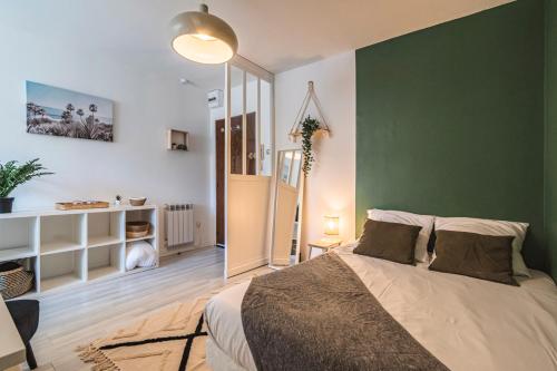 - une chambre avec un mur vert et un lit dans l'établissement Bali - Studio agréable et central - Proche Arena, à Reims