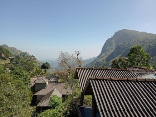 a group of houses with mountains in the background at Shalomi inn ella in Ella