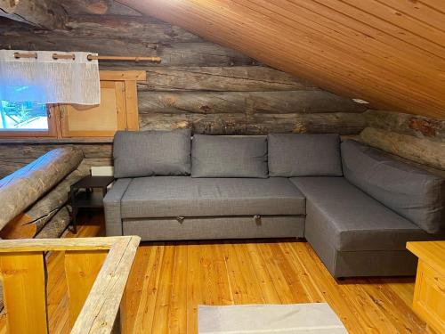 a couch in a room in a log cabin at Holiday Home Sallanhelmi b1 by Interhome in Salla