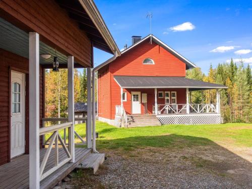 a large orange barn with a porch on a house at Holiday Home Purontupa by Interhome in Sotkamo