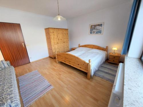 een slaapkamer met een houten bed en een houten vloer bij Apartment Landhaus St- Georg-5 by Interhome in Bad Gastein