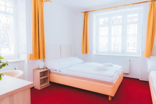 a small bedroom with a bed and a window at Kavárna a penzion REICHL in Králíky