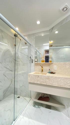 a bathroom with a sink and a glass shower at Blumen Hotel Boutique in Canela