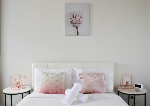 a bedroom with a white bed with two tables at 1 BRM 1 BATH, South Melbourne, Spacious, Balcony in Melbourne