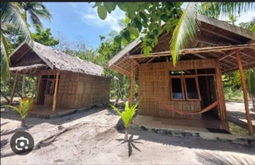 a small building with a sign in front of it at Binmeos Homestay in Waisai