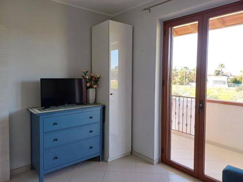 a bedroom with a blue dresser and a balcony at Villa Rosetta in Villaggio Mosè