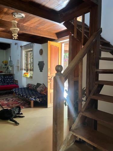 a dog laying on the floor in a living room at The Sunset Chalet! in Anjuna