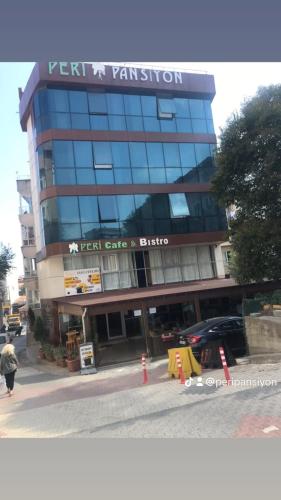 a tall building with a sign on the front of it at Peri Pansiyon in Çınarcık