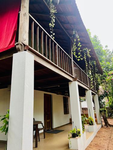 a balcony of a house with plants on it at The Sunset Chalet in Anjuna