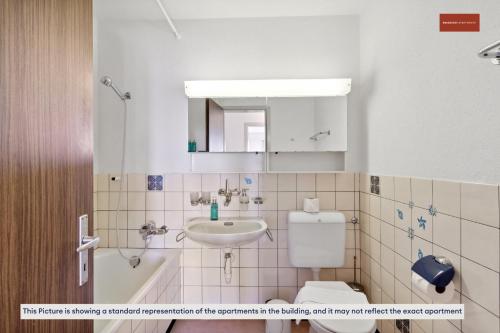 a bathroom with a sink and a toilet and a mirror at Practical Living Space 