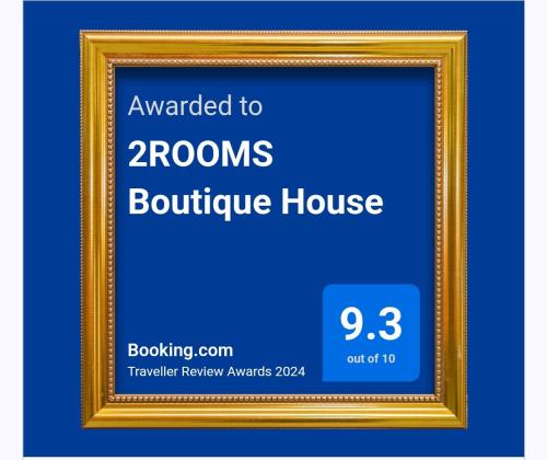 a gold picture frame with the words awarded to roomsoulder house at 2ROOMS Boutique House in Phuket Town