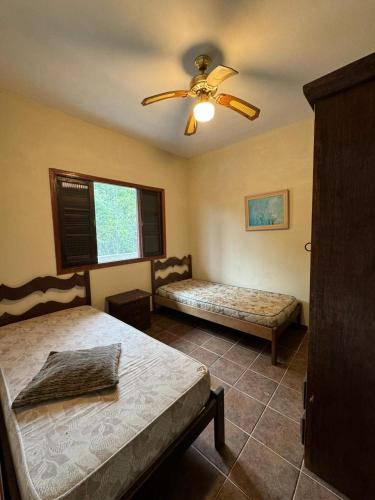 En eller flere senge i et værelse på Casa 5 quartos com Piscina - Sítio na Praia