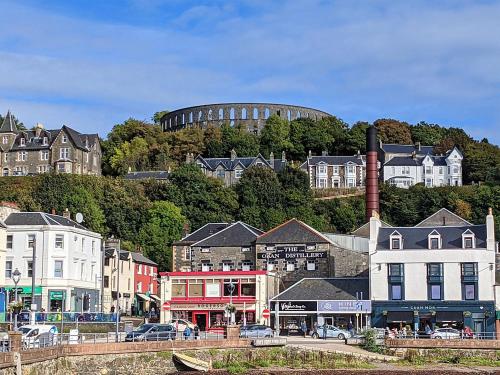 a city with a round building in the background at Campbell Street Apartments in Oban