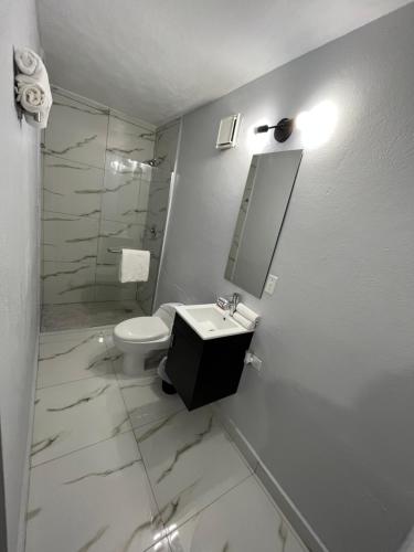 a bathroom with a sink and a toilet and a mirror at Molinos House 3 in Santa Isabel