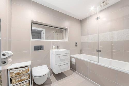 a white bathroom with a toilet and a sink at Charming & Large 1-Bedroom in the Heart of London in London