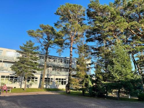 a building with trees in front of a building at Nadmorski in Mrzeżyno