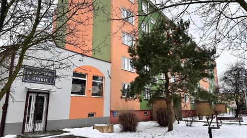 a building with snow on the ground in front of it at 3Klucze in Tomaszów Mazowiecki