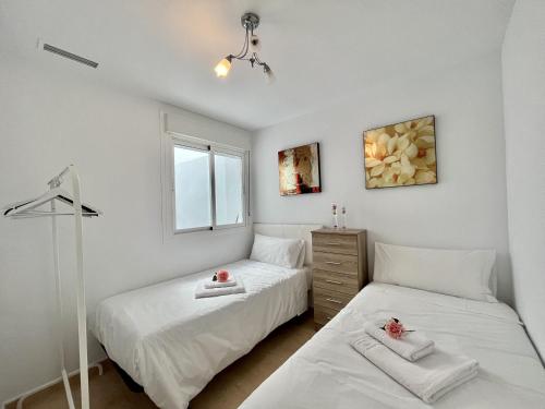 a bedroom with two beds and a window at Dunas Home by Gloove in Gran Alacant