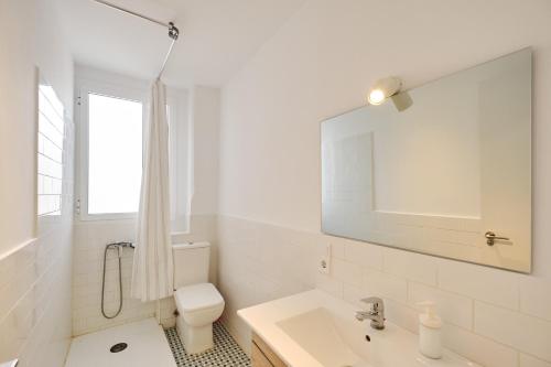 a white bathroom with a toilet and a sink at Mossen flat Patraix in Valencia