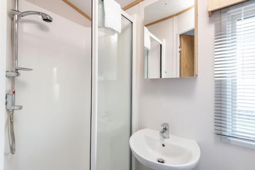 a bathroom with a sink and a shower at Lodge 2 The Silverdale Close to St Andrews in Strathkinness