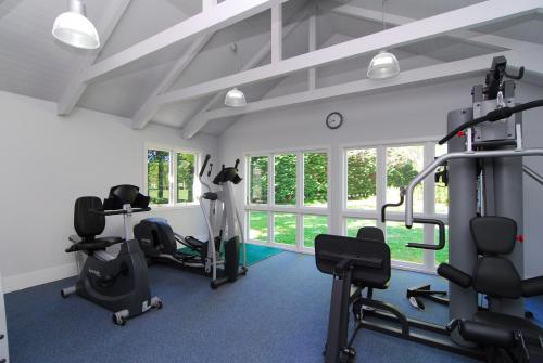 a gym with treadmills and exercise equipment in a room at Mangapapa Hotel in Havelock North