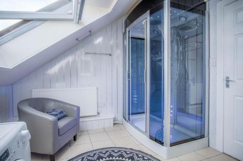 a bathroom with a glass walk in shower at Fulke Street - 2 Bedroom Apartment - Milford Haven in Milford Haven