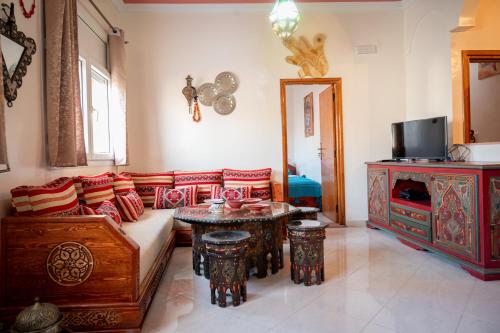 a living room with a couch and a table at Surf Apartment Tamraght N1 Salty Waves in Tamraght Ouzdar
