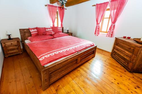 a bedroom with a large wooden bed with red pillows at Zoopark Chomutov in Chomutov