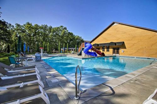 a swimming pool with a slide and a playground at Cozy 'Rustic River Lodge' Near SDC with Pools! in Branson