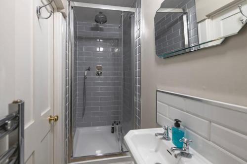 a bathroom with a sink and a shower at The Courtyard Georgian Apartment - 2 Bedrooms in Bath