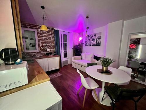 a living room with purple walls and a table at Fabuleux Paris/ Stade de france in Saint-Denis