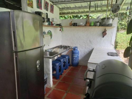 a kitchen with a stainless steel refrigerator and a sink at Villa Migelita Ecolodge in Palmira