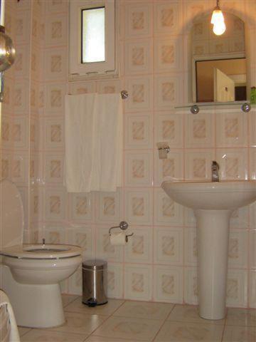 a bathroom with a toilet and a sink at Alize Hotel in Göcek