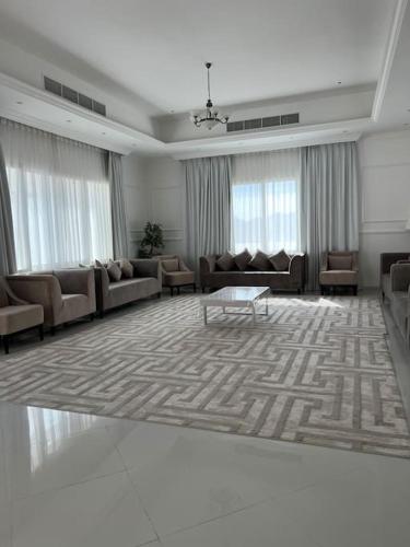 a large living room with couches and a table at Masfout/hatta mountain villa in Sinādil
