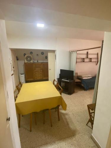 ein Wohnzimmer mit einem gelben Tisch und einem Sofa in der Unterkunft Check and Home - Casino - 6 huéspedes frente a la playa y casino in Mar del Plata
