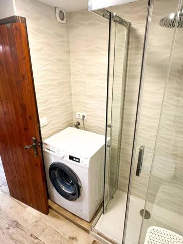 a washing machine in a shower in a bathroom at Appartamento Giuliana in Son Bou