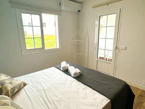 a bedroom with a bed with two towels on it at Appartamento Giuliana in Son Bou