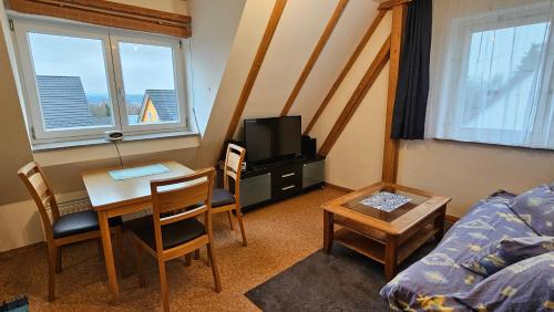 a small living room with a table and a tv at Bei München Ferienwohnung Mahr in Kottgeisering "Mahr" in Kottgeisering