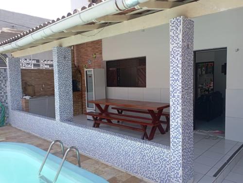 a bathroom with a table and a bath tub at Casa Em Pirangi Praia - RN in Parnamirim