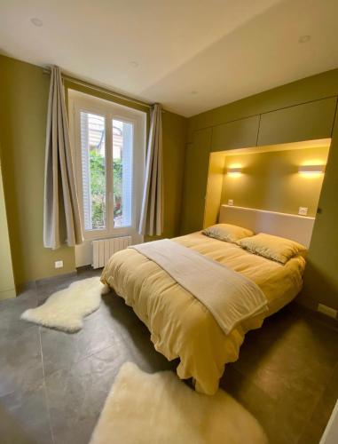 a bedroom with a large bed and a window at Chez les artistes de Ménilmontant in Paris