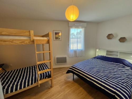 a bedroom with a bunk bed and a ladder at La Cabane Océan 10 min a pied de Mimizan plage Forêt in Mimizan