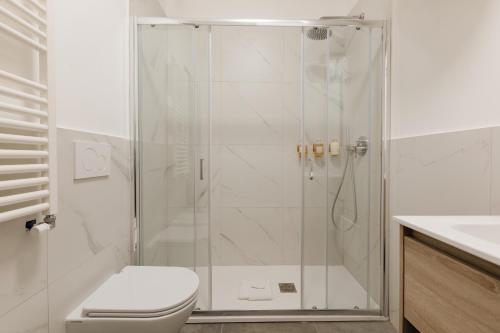 a bathroom with a shower with a toilet and a sink at Sonder Piazza San Pietro in Rome