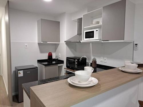 a kitchen with a counter with two bowls on it at Nuevo, apartamento completo, parking, en Cordón Soho in Montevideo