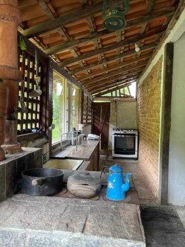 a kitchen with a sink and a stove at Fazenda Kidauana - Mendes in Mendes