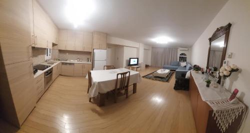 a kitchen and a living room with a table in a room at Maria's House in Thessaloniki