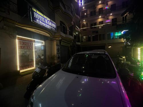 a car parked in front of a building at night at Sai Ganga Cottage by B Grand in Rishīkesh