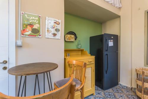 a small kitchen with a table and a refrigerator at 961 Station Apartments in Mar Mikhael in Beirut
