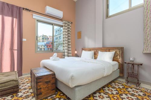 a bedroom with a large bed and a window at 961 Station Apartments in Mar Mikhael in Beirut
