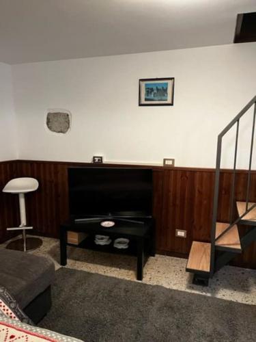 a living room with a piano against a wall at La Cürt Brandon in Frassinetto